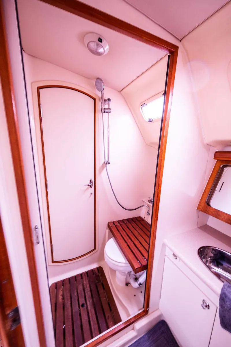 Slide: The Image of 2005 Hunter 38 yacht bathroom with shower, toilet, and sink. - 62