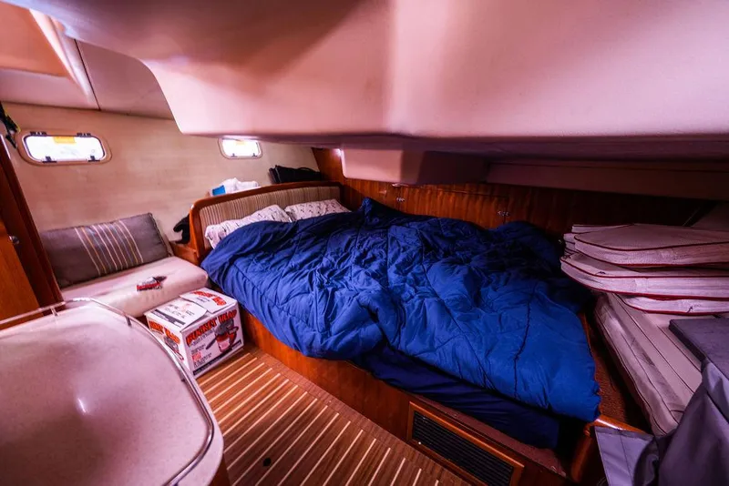 Slide: The Image of Cozy cabin interior of a 2005 Hunter 38 sailboat with a blue bedspread. - 66