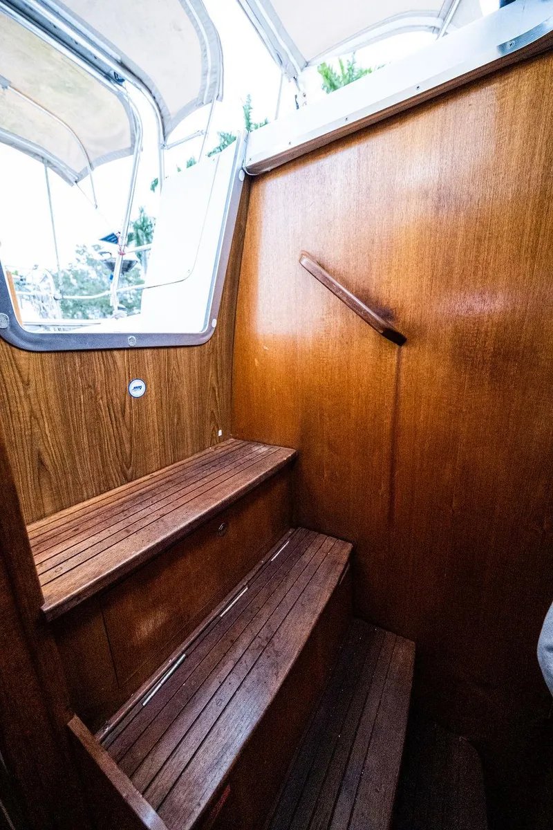 Slide: The Image of Wooden interior stairs on a 2005 Hunter 38 sailboat, leading to the deck. - 68