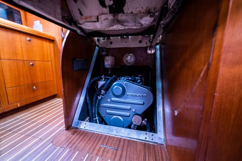 Slide: The Image of Engine compartment of a 2005 Hunter 38 sailboat, featuring a Yanmar engine. - 70