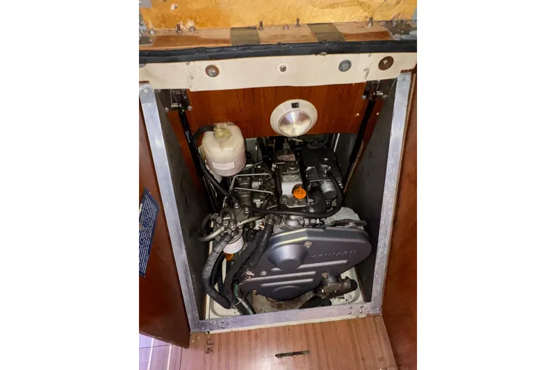 Slide: The Image of Engine compartment of a 2005 Hunter 38 sailboat, showcasing mechanical components. - 71
