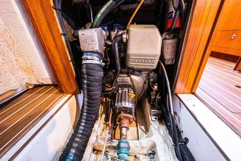 Slide: The Image of Engine compartment of a 2005 Hunter 38 sailboat, featuring a Yanmar engine. - 73