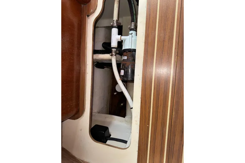 Slide: The Image of Interior plumbing of 2005 Hunter 38 sailboat, featuring pipes and fittings. - 77