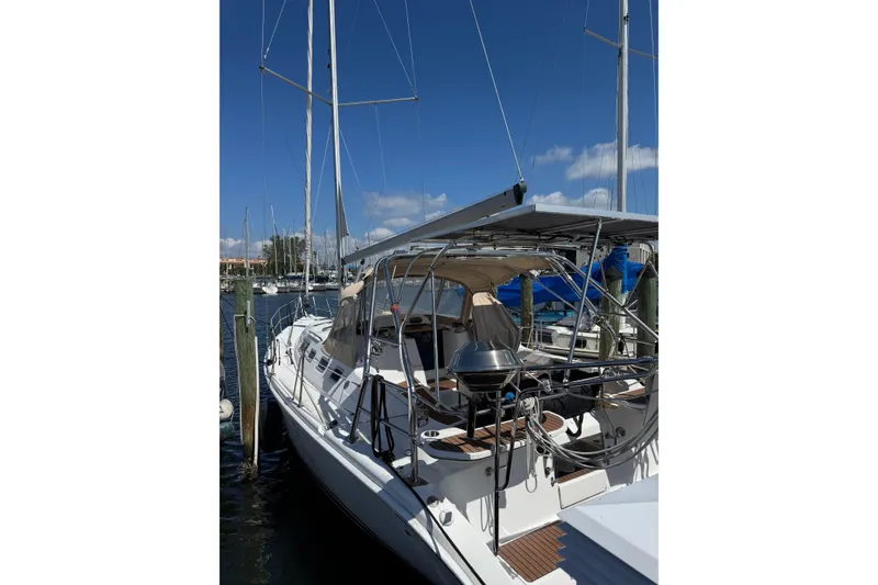Slide: The Image of 2005 Hunter 38 sailboat docked at marina under clear blue sky. - 9