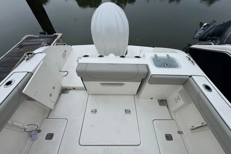 Slide: The Image of 2024 Pursuit S 248 Sport boat deck with seating and storage compartments. - 10