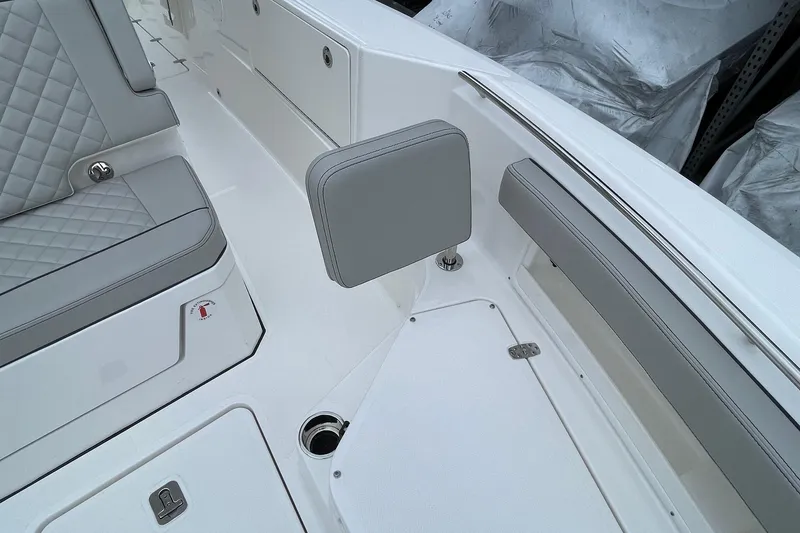 Slide: The Image of 2024 Pursuit S 248 Sport boat interior with gray cushioned seating and sleek design. - 18