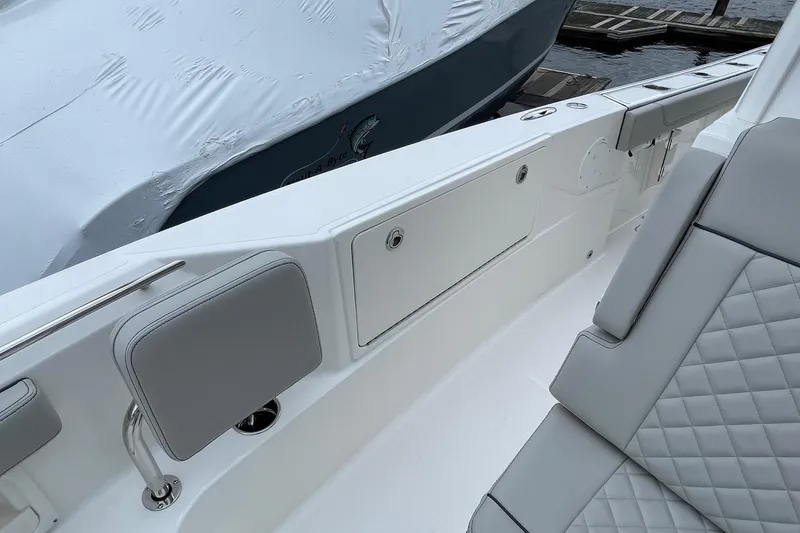 Slide: The Image of 2024 Pursuit S 248 Sport boat interior with cushioned seating and sleek design. - 19