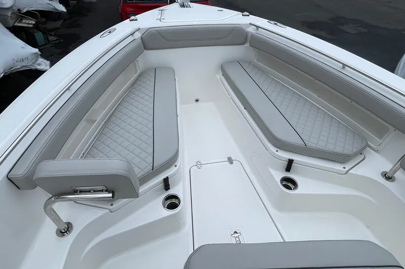 Slide: The Image of 2024 Pursuit S 248 Sport boat interior with cushioned seating and sleek design. - 22