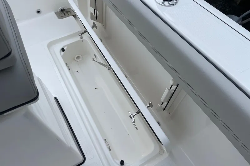 Slide: The Image of 2024 Pursuit S 248 Sport boat storage compartment, open and empty, showcasing interior design. - 25