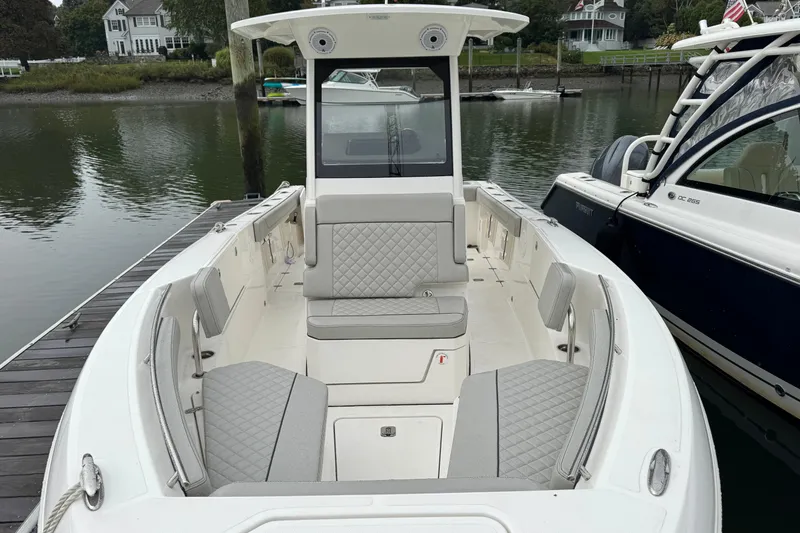 Slide: The Image of 2024 Pursuit S 248 Sport boat docked, featuring spacious seating and modern design. - 6