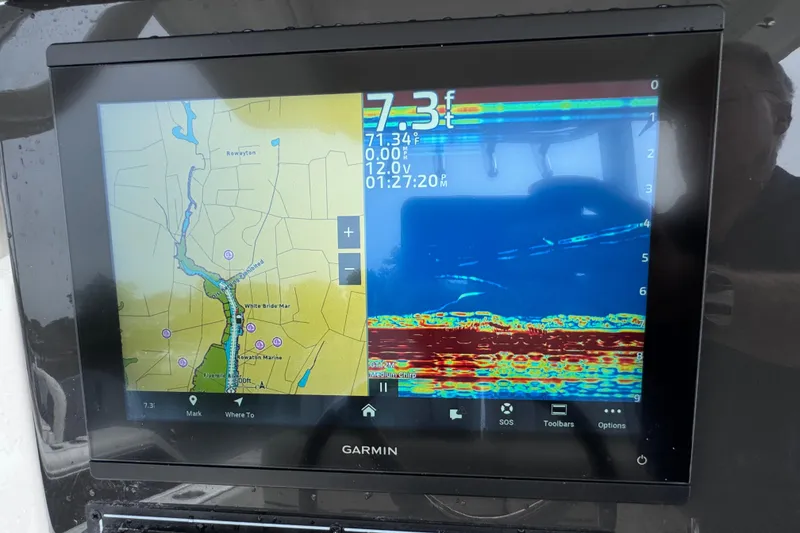 Slide: The Image of Garmin marine display showing navigation map and sonar on 2024 Pursuit S 248 Sport boat. - 7