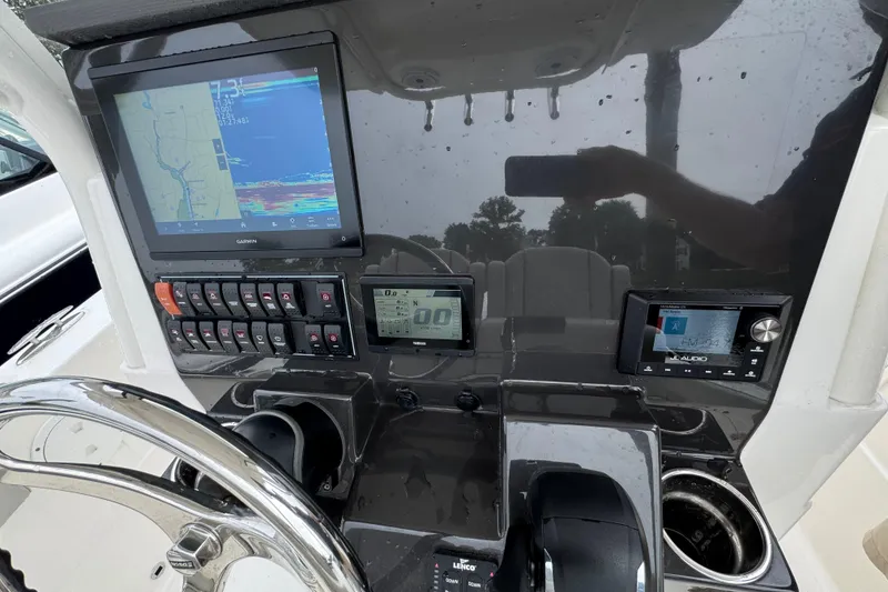 Slide: The Image of 2024 Pursuit S 248 Sport boat dashboard with Garmin navigation and audio controls. - 8