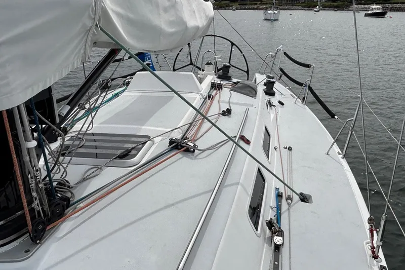 Slide: The Image of 2008 J Boats J/122 sailboat deck with rigging and winches on calm water. - 10
