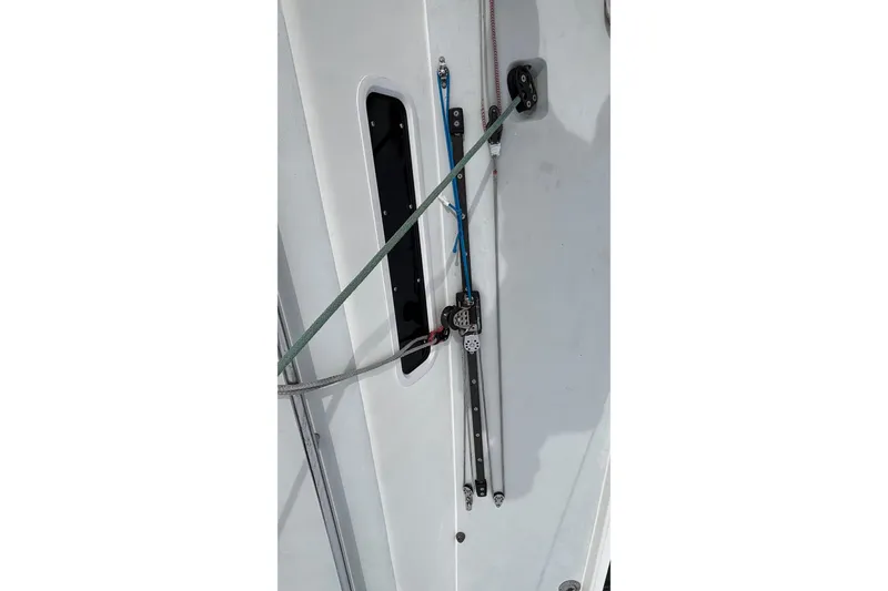 Slide: The Image of Deck rigging on a 2008 J Boats J/122 sailboat, featuring ropes and pulleys. - 14