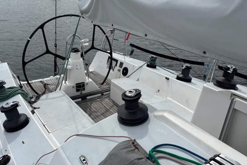 Slide: The Image of 2008 J Boats J/122 sailboat cockpit with steering wheel and winches on calm water. - 19