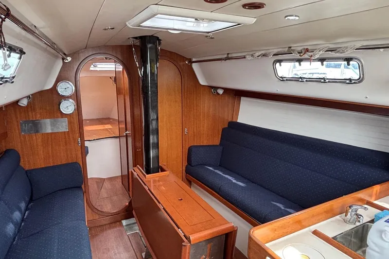 Slide: The Image of Interior of 2008 J Boats J/122 sailboat with wooden finish and blue seating. - 29