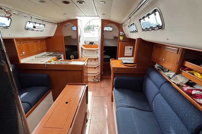 Slide: The Image of Interior of a 2008 J Boats J/122 sailboat with wood cabinetry and blue seating. - 30