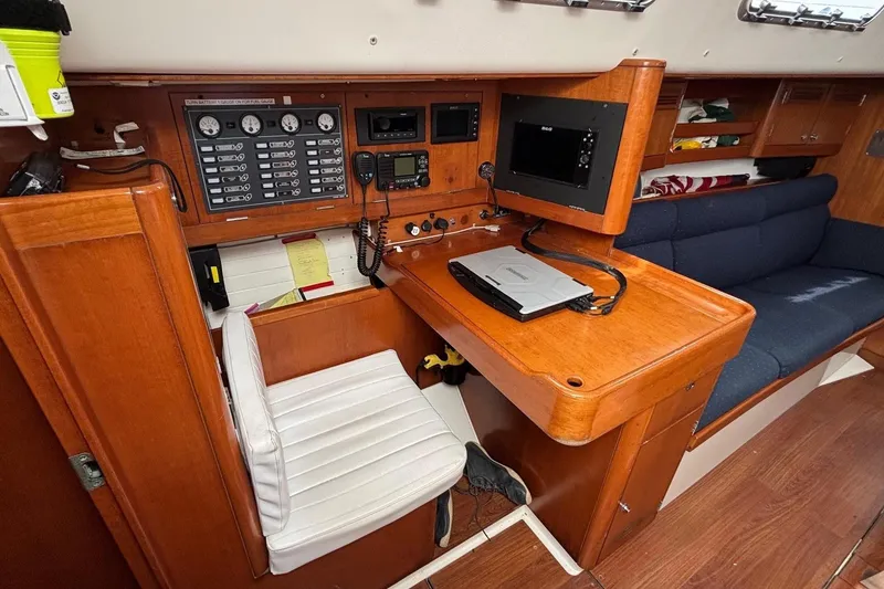 Slide: The Image of 2008 J Boats J/122 interior navigation station with control panel and seating. - 31