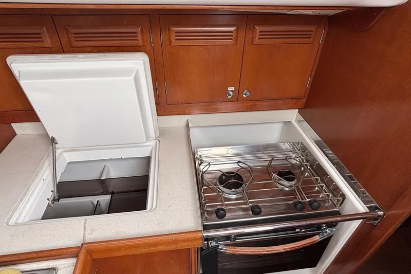 Slide: The Image of 2008 J Boats J/122 yacht kitchen with stove and storage compartments. - 36