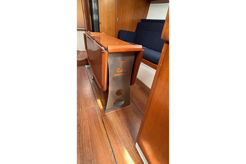 Slide: The Image of Interior of 2008 J Boats J/122 sailboat, featuring wooden flooring and seating. - 39