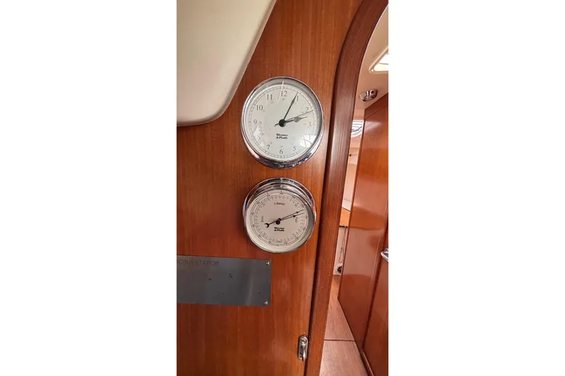 Slide: The Image of Interior of 2008 J Boats J/122 yacht with clock and barometer on wooden panel. - 40
