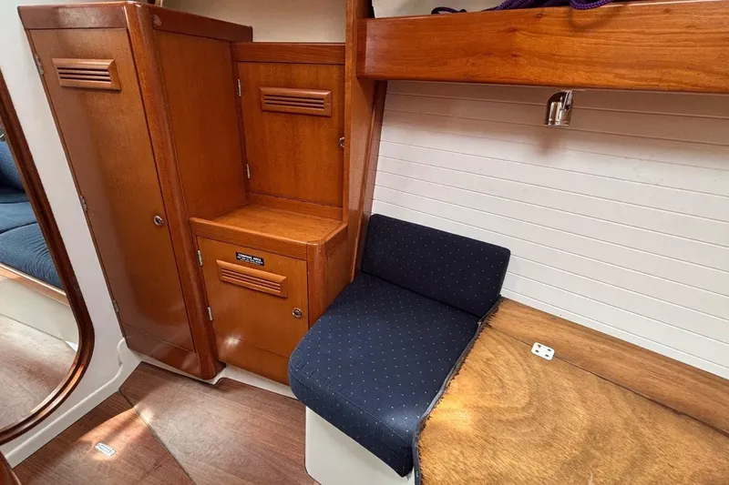 Slide: The Image of Interior of 2008 J Boats J/122 sailboat with wooden cabinetry and blue seating. - 43