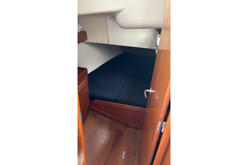 Slide: The Image of 2008 J Boats J/122 cabin interior with wooden finish and cozy sleeping area. - 46