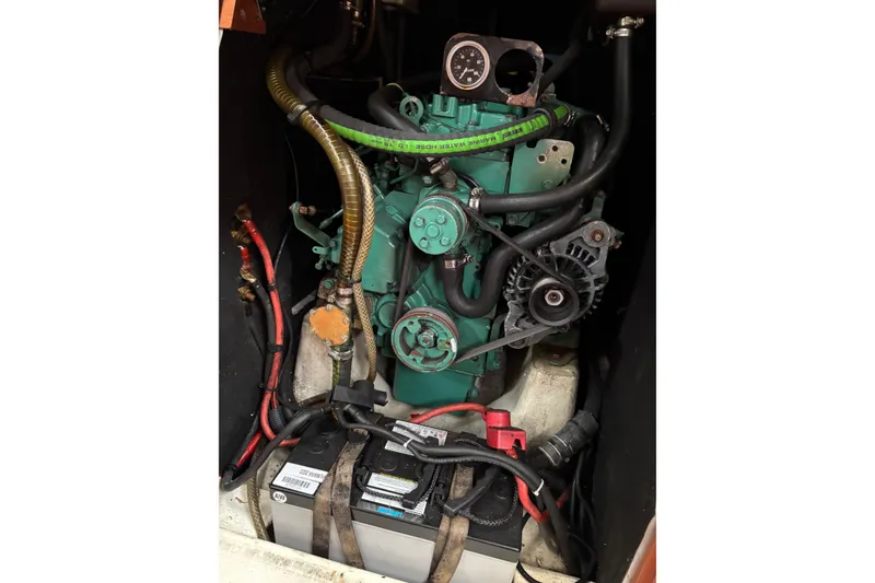 Slide: The Image of Engine compartment of a 2008 J Boats J/122 sailboat, featuring a marine engine and battery. - 48