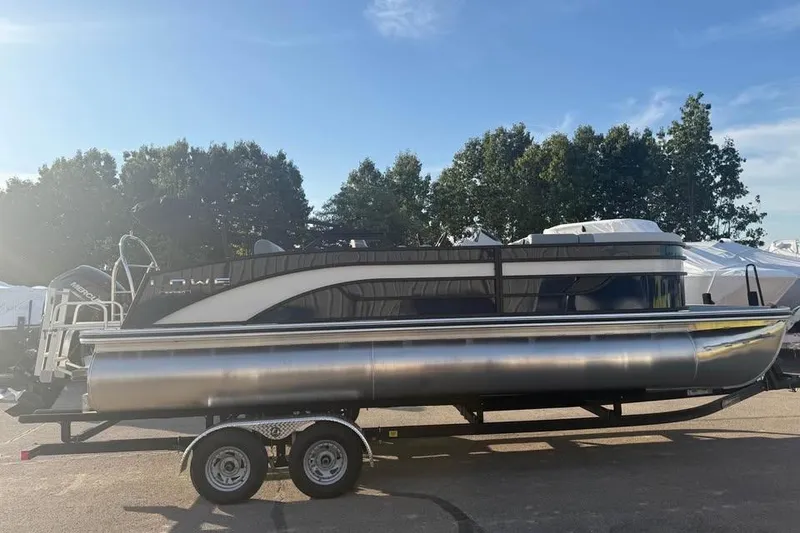 Slide: The Image of 2026 Lowe SS 230 DV pontoon boat on trailer, parked outdoors. - 4