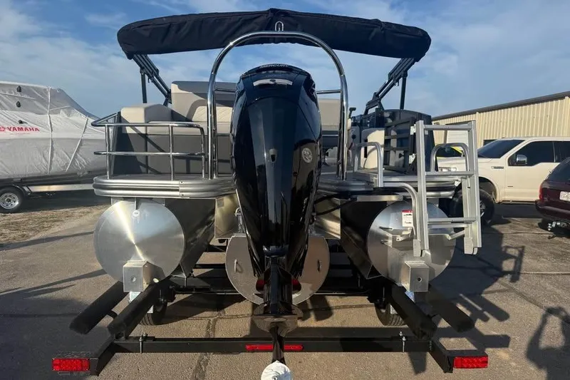 Slide: The Image of 2026 Lowe SS 230 DV pontoon boat with outboard motor, parked on trailer. - 5
