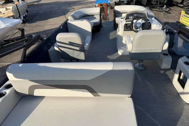 Slide: The Image of 2026 Lowe SS 230 DV pontoon boat interior with modern seating and steering console. - 6