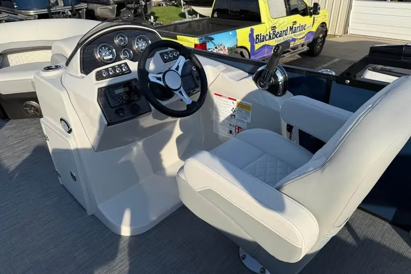 Slide: The Image of 2026 Lowe SS 230 DV boat interior with steering wheel and captain's chair. - 8