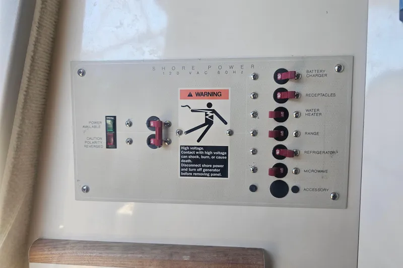 Slide: The Image of Control panel of a 1999 Maxum 2400 SCR boat with warning label and switches. - 23