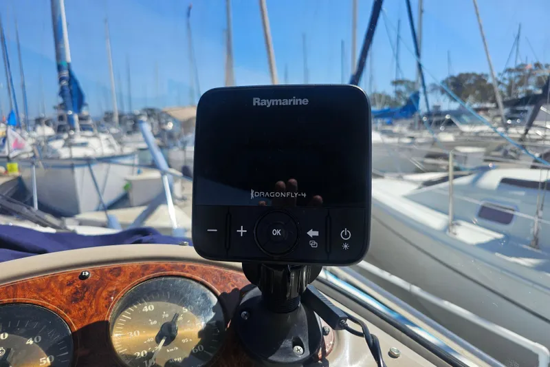 Slide: The Image of Raymarine Dragonfly-4 on 1999 Maxum 2400 SCR boat, marina background. - 3