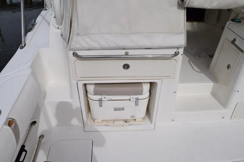 Slide: The Image of 2011 Boston Whaler 345 Conquest boat interior with storage compartment and cooler. - 10
