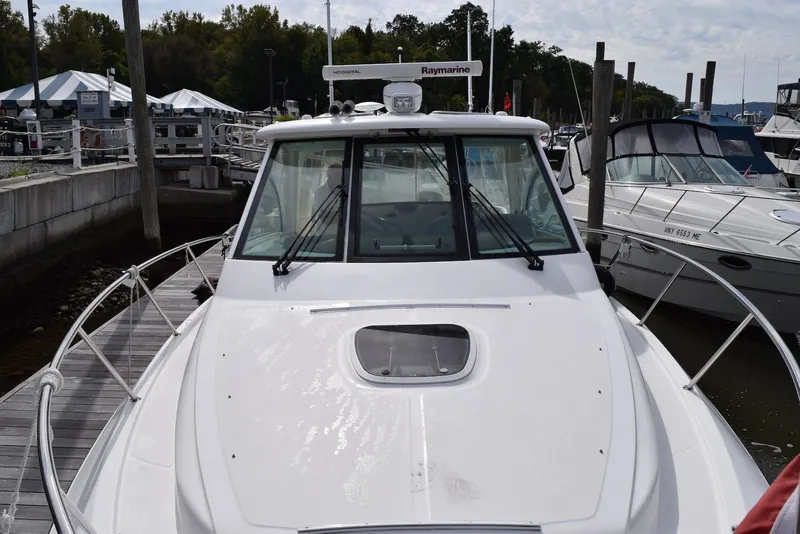 Slide: The Image of 2011 Boston Whaler 345 Conquest docked at marina, front view. - 12