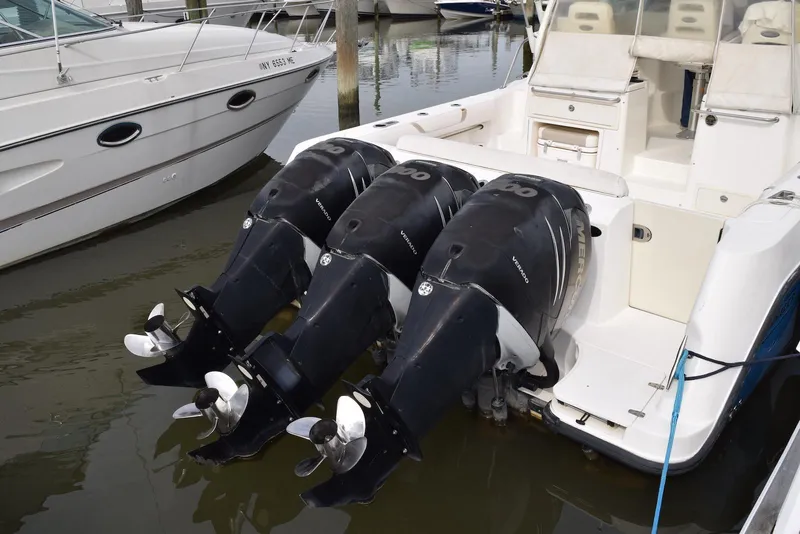 Slide: The Image of 2011 Boston Whaler 345 Conquest with triple Mercury outboard engines docked. - 13
