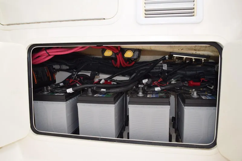 Slide: The Image of Battery compartment of a 2011 Boston Whaler 345 Conquest boat, showing multiple batteries and wiring. - 15