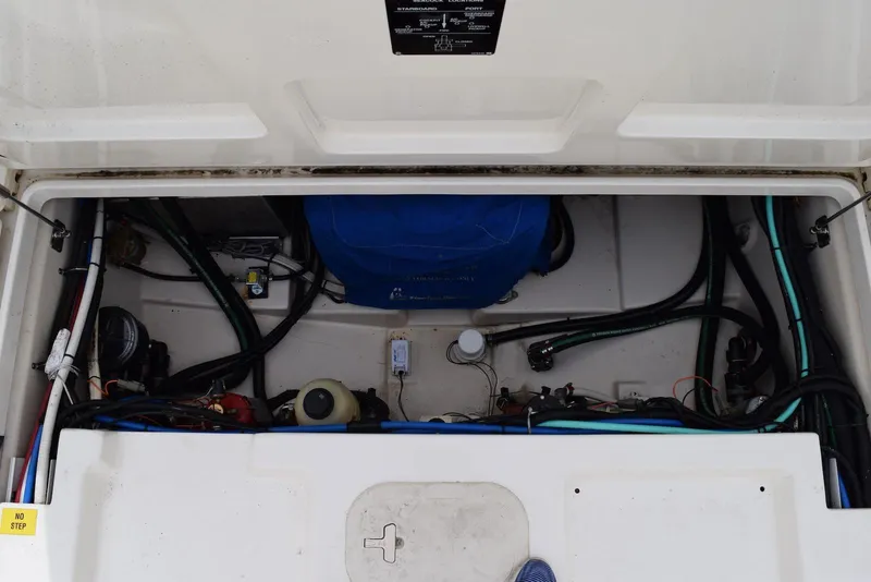Slide: The Image of Engine compartment of a 2011 Boston Whaler 345 Conquest, showcasing wiring and components. - 16