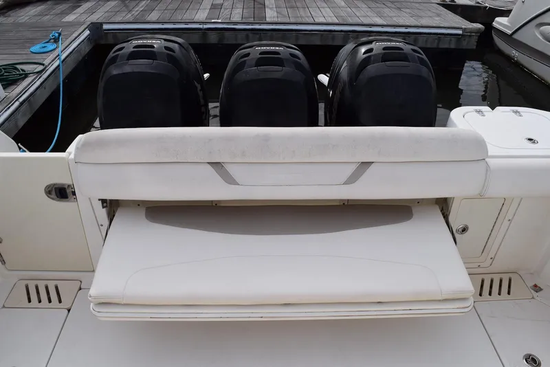 Slide: The Image of 2011 Boston Whaler 345 Conquest boat with triple outboard engines at dock. - 4
