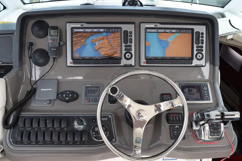 Slide: The Image of Control panel of a 2011 Boston Whaler 345 Conquest with navigation screens and steering wheel. - 6