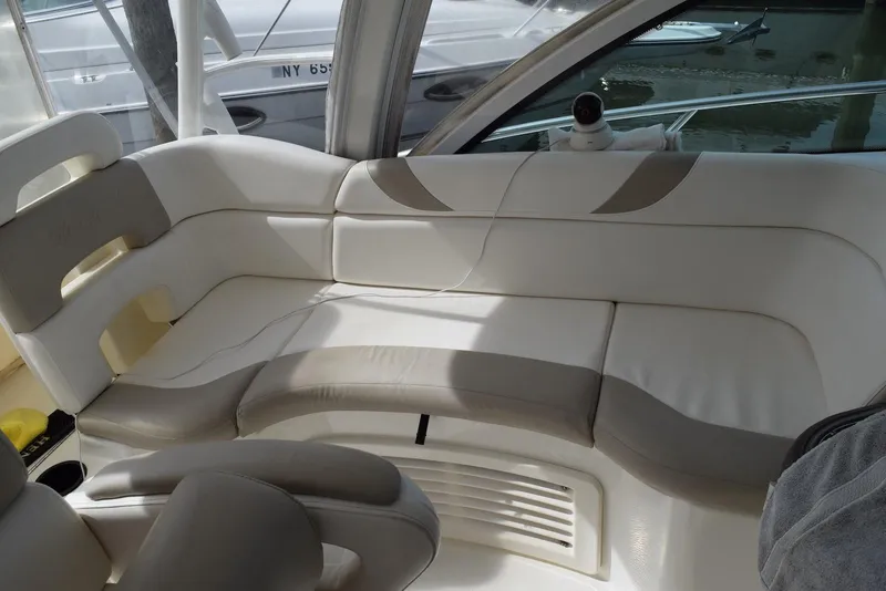 Slide: The Image of 2011 Boston Whaler 345 Conquest interior seating with beige and white upholstery. - 7