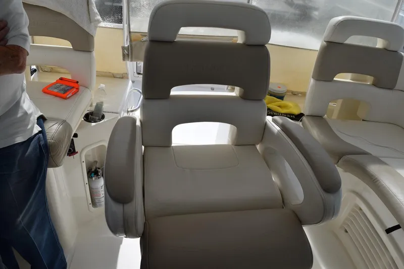 Slide: The Image of 2011 Boston Whaler 345 Conquest interior seating with armrests and cup holder. - 8