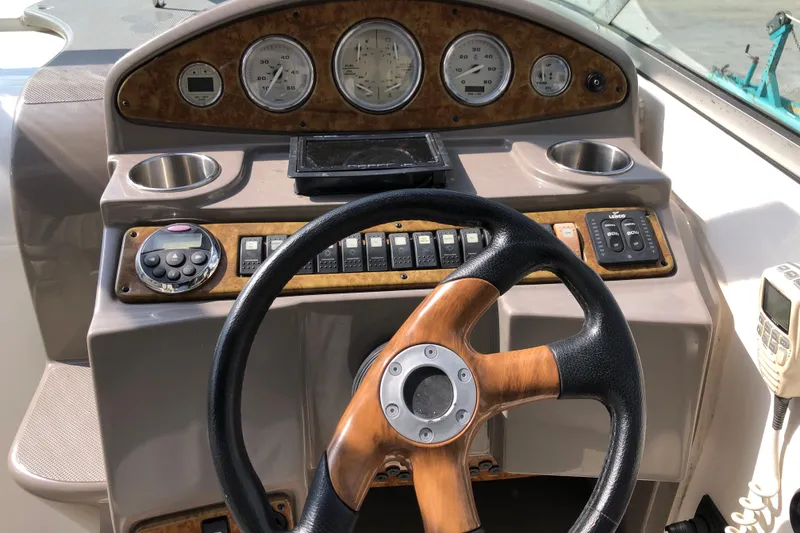 Slide: The Image of 2008 Rinker 260 Express Cruiser dashboard with steering wheel and control panel. - 10