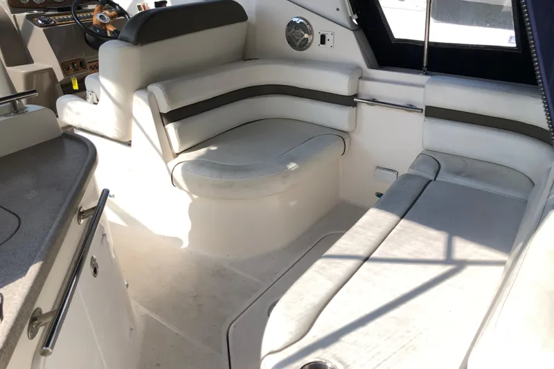 Slide: The Image of 2008 Rinker 260 Express Cruiser interior with white seating and steering area. - 4