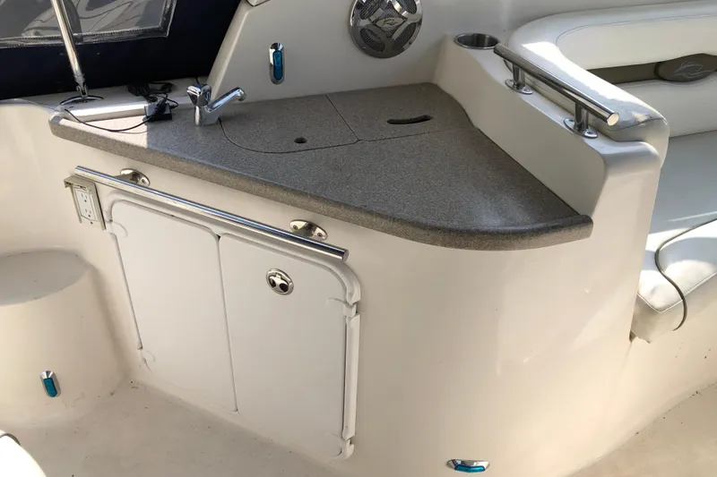 Slide: The Image of 2008 Rinker 260 Express Cruiser interior with sink and storage area. - 5