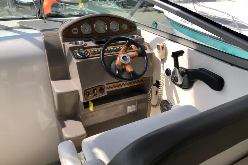 Slide: The Image of 2008 Rinker 260 Express Cruiser helm with steering wheel and control panel. - 9