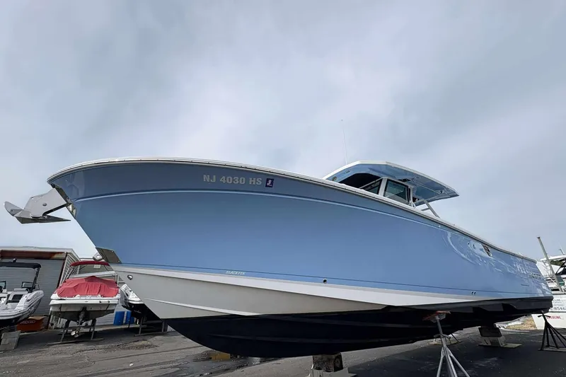 The Image of 2023 Blackfin 332cc boat in light blue, docked on land, side view. - 0