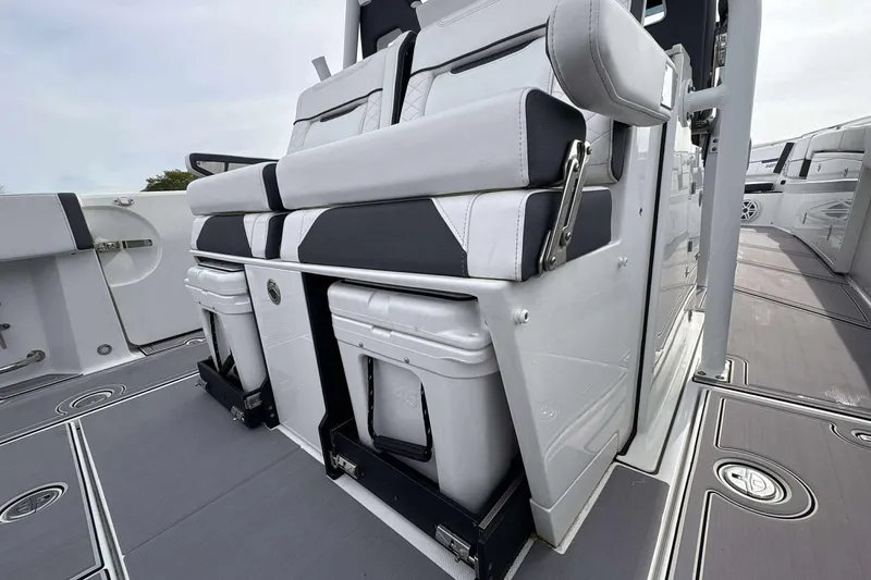 Slide: The Image of 2023 Blackfin 332cc boat interior with cushioned seating and storage compartments. - 15