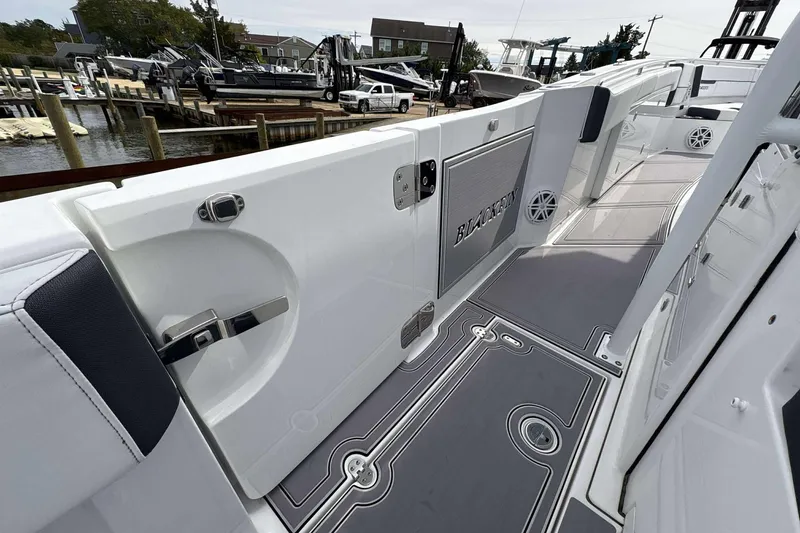 Slide: The Image of 2023 Blackfin 332cc boat interior with sleek design and modern features at a marina. - 16